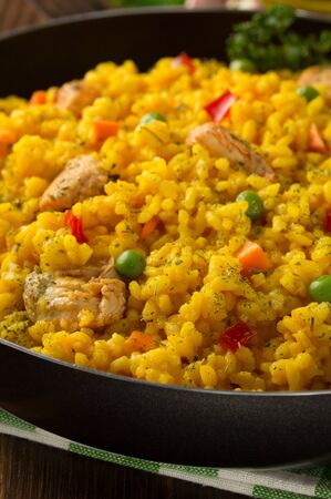 frying pan full of rice on wooden backgroundの写真素材