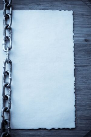 chain and old vintage ancient paper at wooden backgroundの写真素材