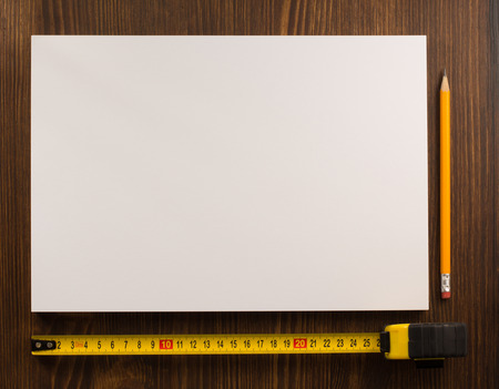 tape measure and pencil on wooden textureの写真素材