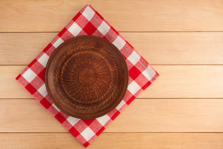 kitchen utensils at cloth napkin on wooden backgroundの写真素材