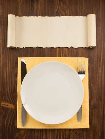 plate, knife and fork  on wooden backgroundの写真素材