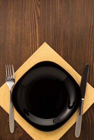 kitchen utensils at cloth napkin on wooden backgroundの写真素材
