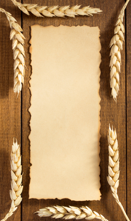 ears of wheat on wooden backgroundの写真素材
