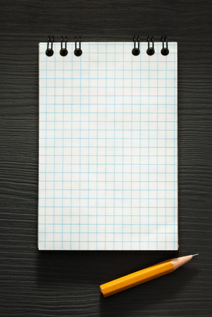 checked notebook  on wooden backgroundの写真素材