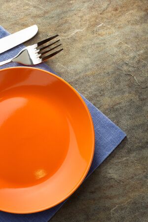 plate, knife and fork on napkin clothの写真素材