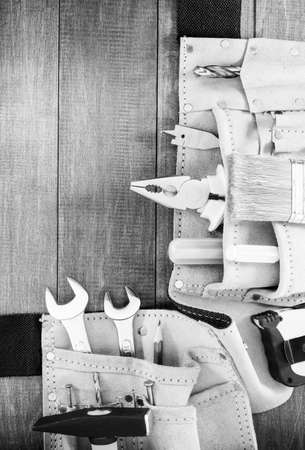 tools and instruments in belt on wooden backgroundの写真素材