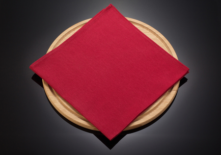 napkin cloth and cutting board on black backgroundの写真素材