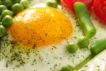 fried egg in ceramic plateの写真素材