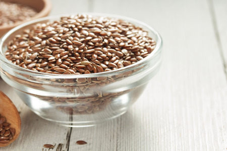 flax seeds in bowl on table backgroundの写真素材