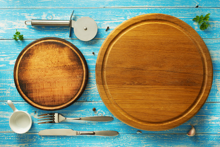 pizza cutting board and utensils at wooden tableの写真素材