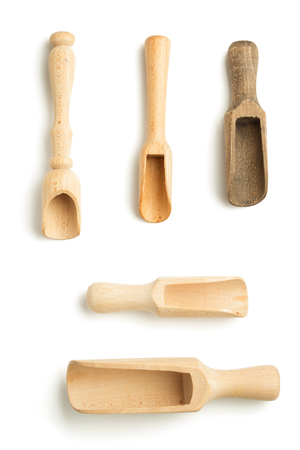 wooden spice scoop isolated on whiteの写真素材