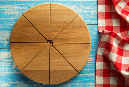 pizza cutting board at wooden backgroundの写真素材
