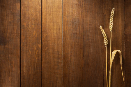 ears of wheat on wooden backgroundの写真素材