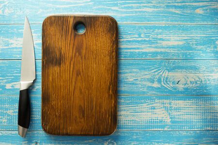 cutting board at wooden tableの写真素材