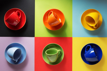 empty cup and saucer at colorful paper backgroundの写真素材
