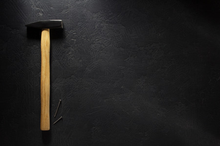 hammer tool and nail at black  backgroundの写真素材