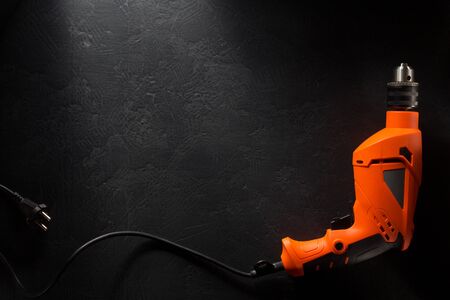 electric drill with cord on black backgroundの写真素材