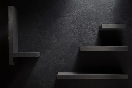 wooden shelf  on black backgroundの写真素材