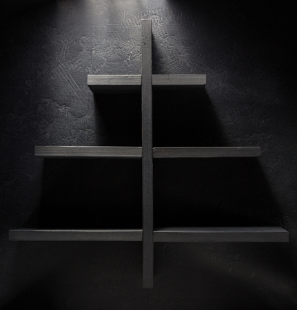 shelf and black wall on wooden backgroundの写真素材