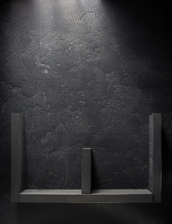 shelf and black wall on wooden backgroundの写真素材