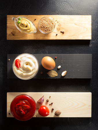 tomato sauce, mayonnaise and mustard in bowl on wooden backgroundの写真素材