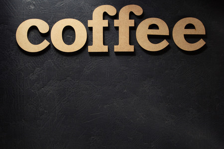 coffee wooden letters on black backgroundの写真素材