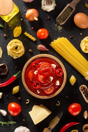 tomato sauce in bowl on black background textureの写真素材