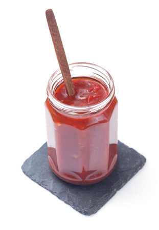 tomato sauce in glass jar on white backgroundの写真素材