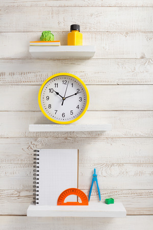 school supplies and tools on white wooden shelfの写真素材