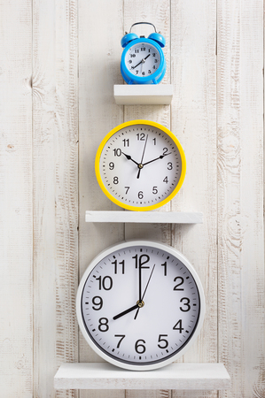wall clock at wooden background textureの写真素材