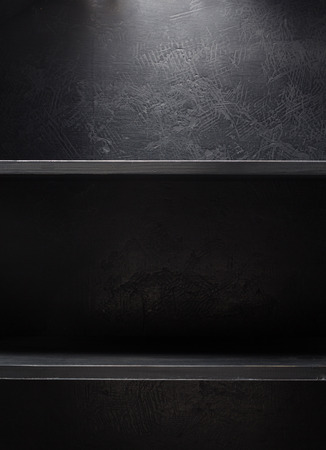 wooden shelf at black wall  backgroundの写真素材