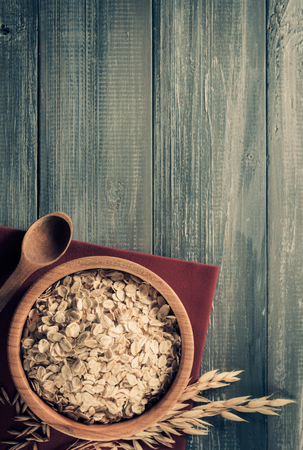 bowl of oat flakes at wooden backgroundの写真素材