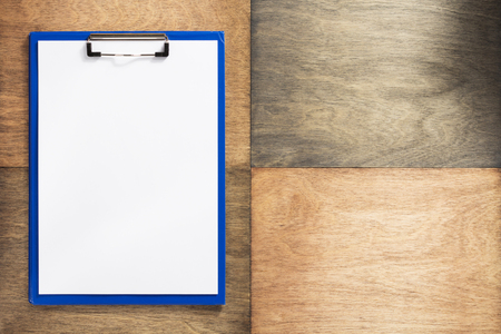 paper clipboard at wooden background textureの写真素材