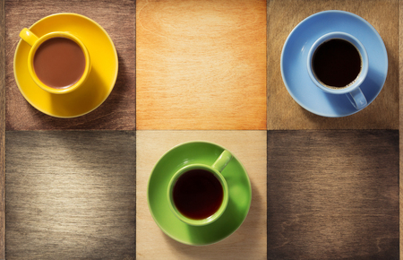 cup of coffee, tea and cacao at wooden backgroundの写真素材