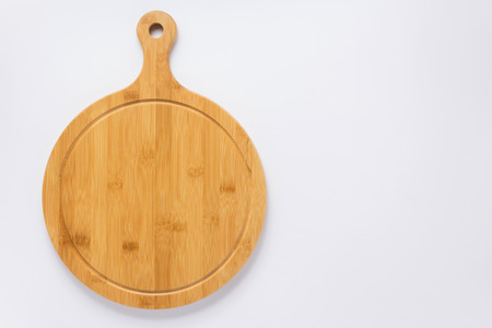 wooden pizza or bread cutting board at white background, top viewの写真素材