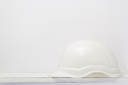 construction helmet on wooden shelf at white background texture wallの写真素材