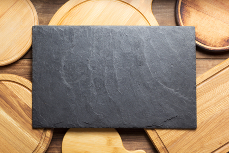 cutting board at wooden plank table board background, top viewの写真素材