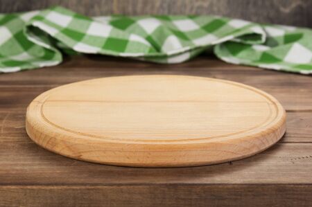 pizza cutting and napkin tablecloth board at rustic wooden table, in front plank background