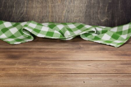 cloth napkin at rustic table in front, wooden plank board backgroundの写真素材