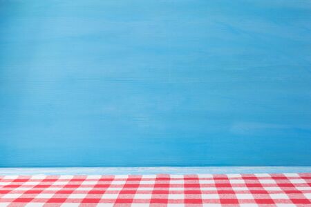 cloth napkin at rustic table in front, wooden plank board background