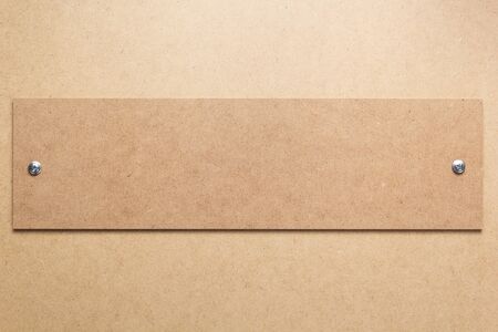 wooden and fiber board background as texture surface  with screws, top view