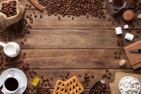 cup of coffee and beans on wooden background table, top view