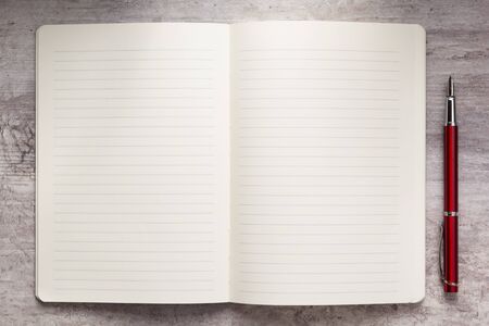 notepad or notebook paper at stone background surface table, top viewの写真素材