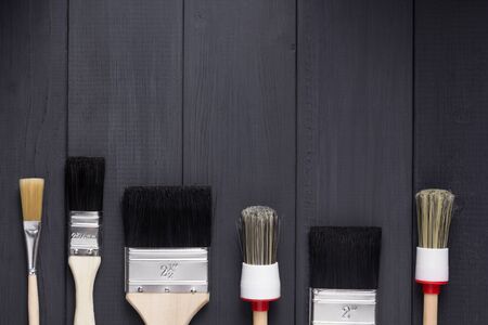 paint brush on plank wooden board table background texture