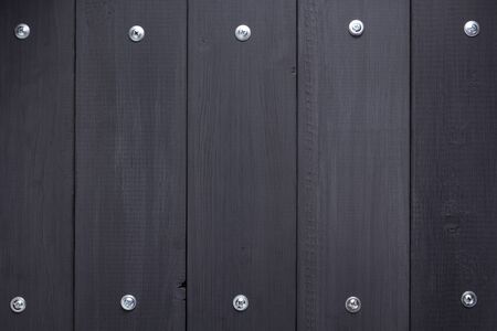 black wooden background as texture surface with screwsの写真素材