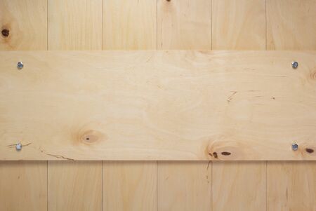 nameplate or wall sign at wooden board plywood background as texture surfaceの写真素材