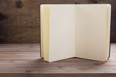 notepad or paper book at wooden table background surface table