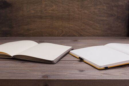 notepad or paper notebook at wooden table background surface table