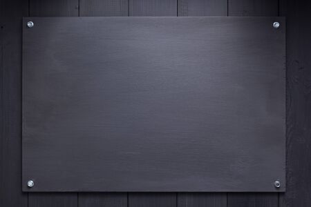 black wooden board with screws