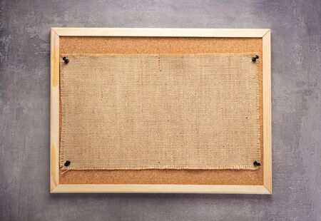 sheet of sack hessian burlap texture pinned at corkboard as background